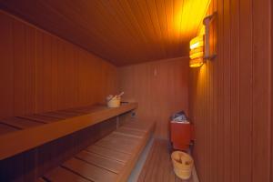a sauna with a bench and a toilet in it at Smart Luxury - Private Gym, Hot Tub & Sauna in Keflavík