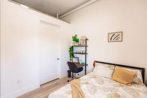 a bedroom with a bed and a desk with a chair at Aerie Apartments in Miami