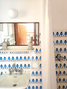 a bathroom with a sink and a mirror at TETRAKTYS estate in Ágios Matthaíos