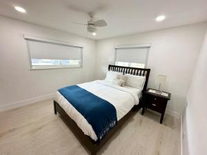 a bedroom with a large bed and a window at Good Vibes House with private pool in Dania Beach