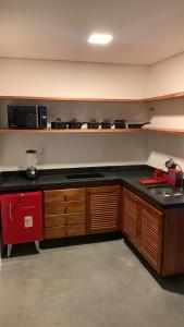 a kitchen with a counter top and a microwave at Dourados Villas Suites in São Miguel do Gostoso +23 photos