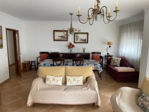 een woonkamer met een bank en een tafel bij Casa dos Pexins in Nazaré