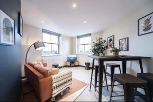 a living room with a couch and a table at Bright and Spacious - 2 Bed Flat w/ Jacuzzi in Crystal Palace