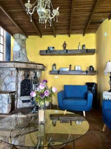 a living room with a blue couch and a fireplace at Casa de campo - Fundo El Alisal in Cajamarca