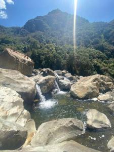 a river with two waterfalls in the middle of rocks at Casa de campo - Fundo El Alisal in Cajamarca