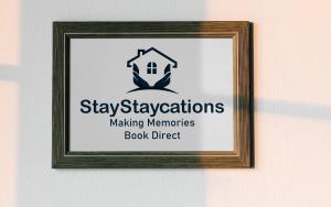 a picture of a sign in a frame on a wall at Herbert House by StayStaycations in Treorky