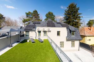 an image of a house with solar panels on the roof at PARK Apartmanok in Balatonszárszó
