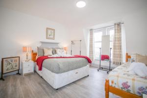 a bedroom with a large bed and a window at Telford Rd 5 Bedroom House Inverness in Inverness