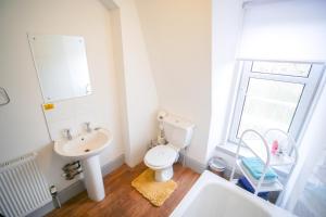 a bathroom with a white toilet and a sink at Telford Rd 5 Bedroom House Inverness in Inverness