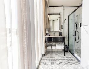 a bathroom with a sink and a mirror at Le Capitole Hotel in Quebec City