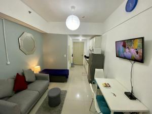 a living room with a couch and a table at Cozy Studio with SM Jazz Mall "12 floor" in Manila