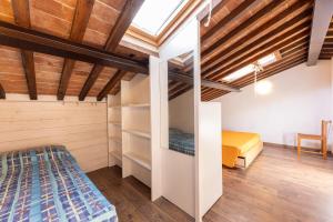 a bedroom with wooden ceilings and a bed in a room at La Fortezza - Goelba in Marciana