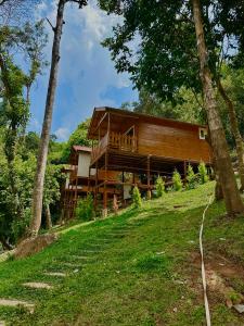 a wooden house on a hill with trees at Coorg Jungle Mist in Madikeri