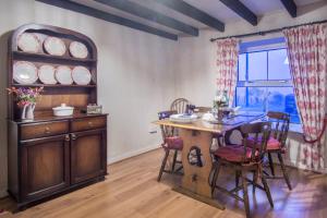 a dining room with a wooden table and chairs at Mynydd Crwn Bach Clynderwen in Clynderwen