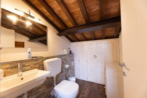 a bathroom with a white toilet and a sink at La Fortezza - Goelba in Marciana +15 photos