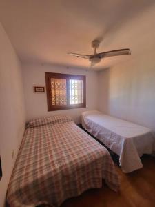 a bedroom with two beds and a window at BERJA33 in Roquetas de Mar