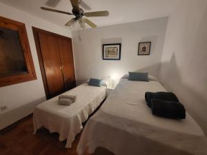 a bedroom with two beds and a ceiling fan at BERJA33 in Roquetas de Mar