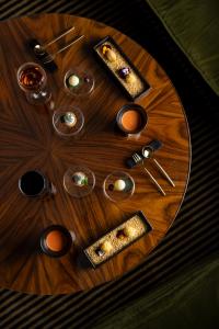 a wooden table with dishes and utensils on it at Hotel Lord Byron - Small Luxury Hotels of the World in Rome