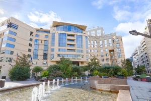 a water fountain in front of a building at Evergreen Laurel Hotel in Levallois-Perret