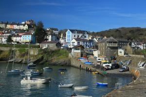 a group of boats are docked in a harbor at Ty Ceiniog New Quay in Cross Inn