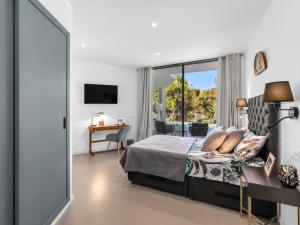 a bedroom with a bed and a sliding glass door at Villa cala Vinyas in Cala Vinyes