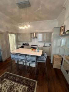 a kitchen with a table and chairs in a room at Modern Apartment in Holland Park in London