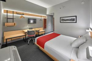 a hotel room with a bed and a desk at City Express by Marriott Saltillo Sur in Saltillo +43 photos