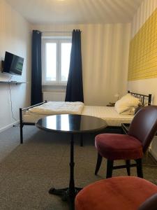 a room with a bed and a table and a bed at Downtown Apartments in Bremen