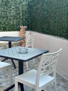 two tables and chairs with a teddy bear in the background at Annabella Bed and Breakfast in Giffoni Valle Piana