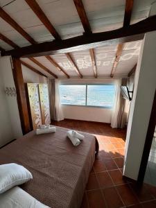 a bedroom with a bed and a large window at Golden Home in Anzio