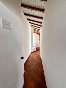 a hallway with a white wall and a ceiling at Golden Home in Anzio