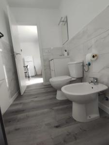 a bathroom with two toilets and a sink at Vista Playa Blanca in Puerto del Rosario