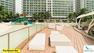 a balcony with white benches and a playground at Azure Urban Resort Residences in Manila