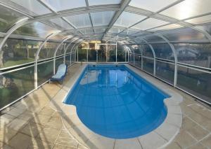 an indoor swimming pool with a glass ceiling at Casa Begoña - 7803 in Castillo