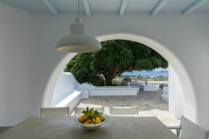 a table with a bowl of fruit on top of it at Villa Maira with Seaview and Private Swimming Pool in Drios