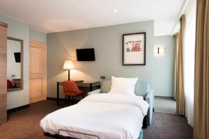 a hotel room with a bed and a desk at Aragon House in Bruges