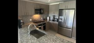 a kitchen with a stainless steel refrigerator and granite counter tops at 2 bed 2 bath Luxury Condo in Miami