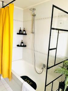 a bathroom with a shower with a yellow shower curtain at Yellow House in Teramo