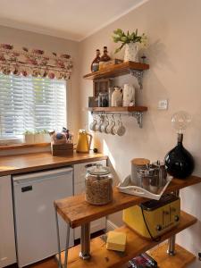 a kitchen with wooden counters and a counter top at The Garden Annexe in Longhope