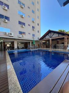 a large swimming pool in front of a building at Nayru Hotel in Toledo