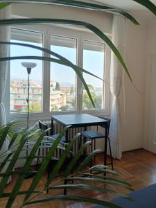 a room with a table and a plant in front of a window at MAX and SEA parking in Sanremo