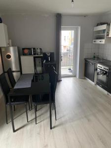 a kitchen and dining room with a table and chairs at Cozy 2 Rooms Apartment in Bochum