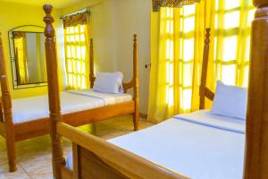 a bedroom with two bunk beds and a mirror at Nv Fort Lugard Hotel Iganga in Iganga