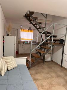 a spiral staircase in a room with a kitchen at La Casa de Emma in General Roca