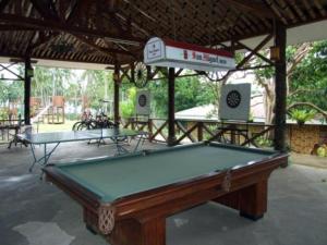 a pool table sitting inside of a pavilion at Camiguin Highland Resort in Mambajao
