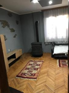 - un salon avec un poêle à bois et un tapis dans l'établissement Vikendica DUNAV Vinci, à Golubac