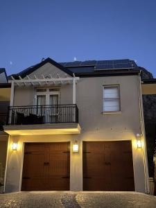 a house with solar panels on the roof at Mountain View 1-Bedroom Villa in Franschhoek in Franschhoek