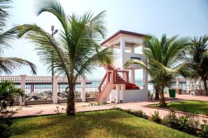 a playground in front of a building with palm trees at Beautiful 1-Bed Room in Greater Accra Region 1 in Oshien