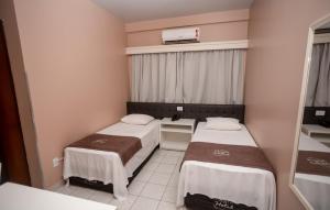 Postel nebo postele na pokoji v ubytování Nayru Hotel