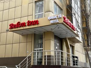 a building with a neon hotel sign on it at Belon inn in Astana